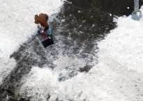 Man shoveling snow on driveway